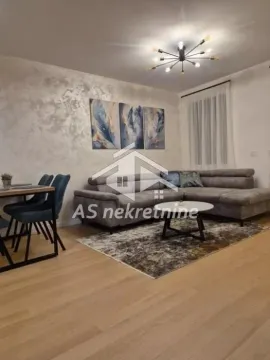 Living room with a sofa, coffee table and dining table. - image 6