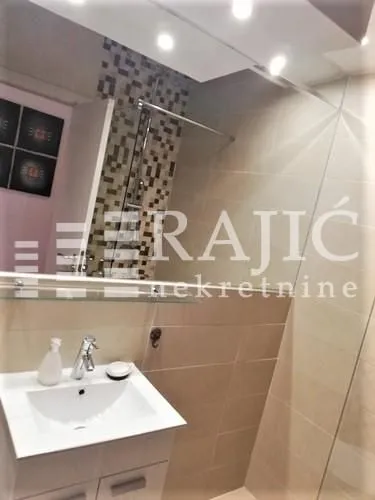 Modern bathroom with a sink and a shower cabin.