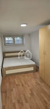 Smaller bedroom with a double bed and a wooden wardrobe. - image 8