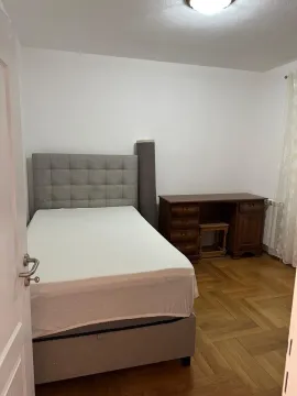 Bedroom with a double bed, desk, and parquet flooring. - image 11