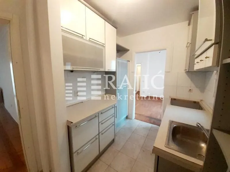 Smaller kitchen with cabinets and a sink.