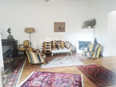 Spacious living room with classical furniture and a fireplace. - image 3