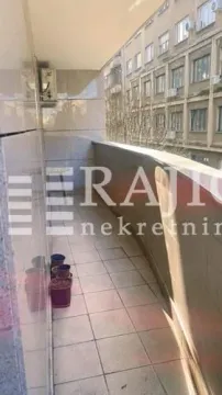 Narrow balcony with ceramic tiles and a view of the adjacent building. - image 11