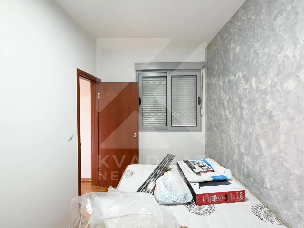 Unfurnished room with a bed and an open door.