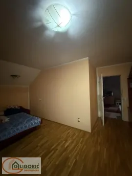 Smaller bedroom with a bed and laminate flooring. - image 8