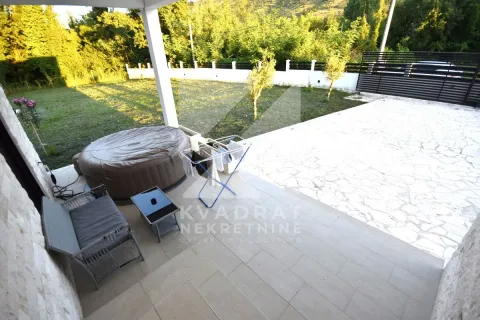 Covered terrace with seating furniture and a hot tub in front of the yard. - image 21