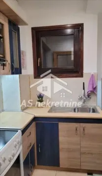 Manja kuhinja sa drvenim elementima i sudoperom ispod prozora. - image 15