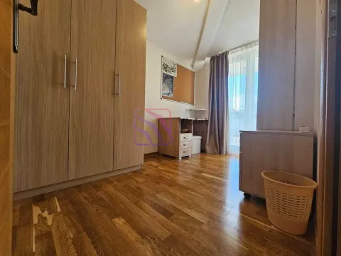 Furnished bedroom with a large wardrobe and wooden flooring. - image 10