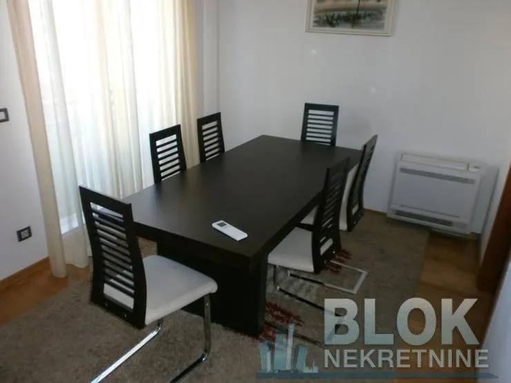 Dining area with a dark wooden table and six chairs.