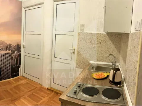 Smaller kitchen with a sink, stove, and white cabinetry. - image 5