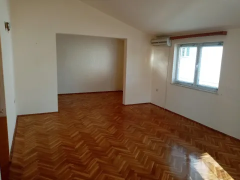 Empty room with parquet flooring and a window. - image 9