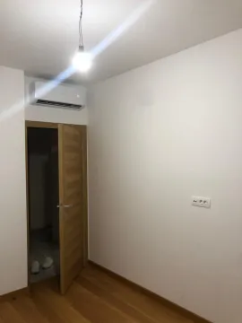 An empty room with a wooden floor and air conditioning. - image 3