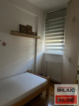 Smaller bedroom with a bed, wardrobe, and window. - image 4