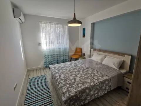 Bright bedroom with a double bed, window, and air conditioning. - image 7