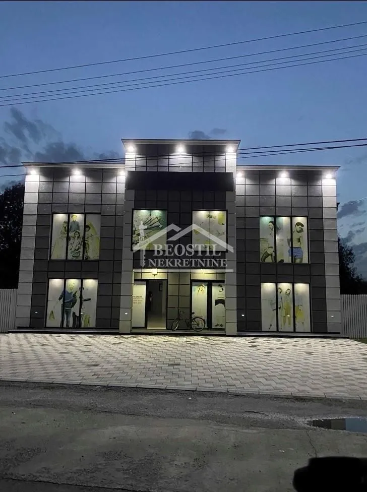 View of the exterior of the commercial building with lighting at dusk.