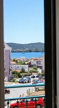 Pogled sa prozora na okolno naselje, ulicu i more u daljini. - image 12