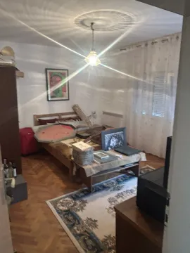 Bedroom with a wooden bed and a rug. - image 15