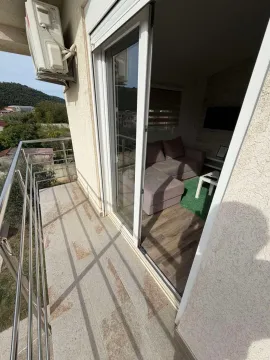 View from the balcony towards the surroundings and the living room entrance. - image 6