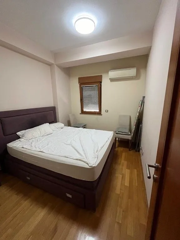 Spavaća soba sa bračnim krevetom, klima-uređajem i prozorom.