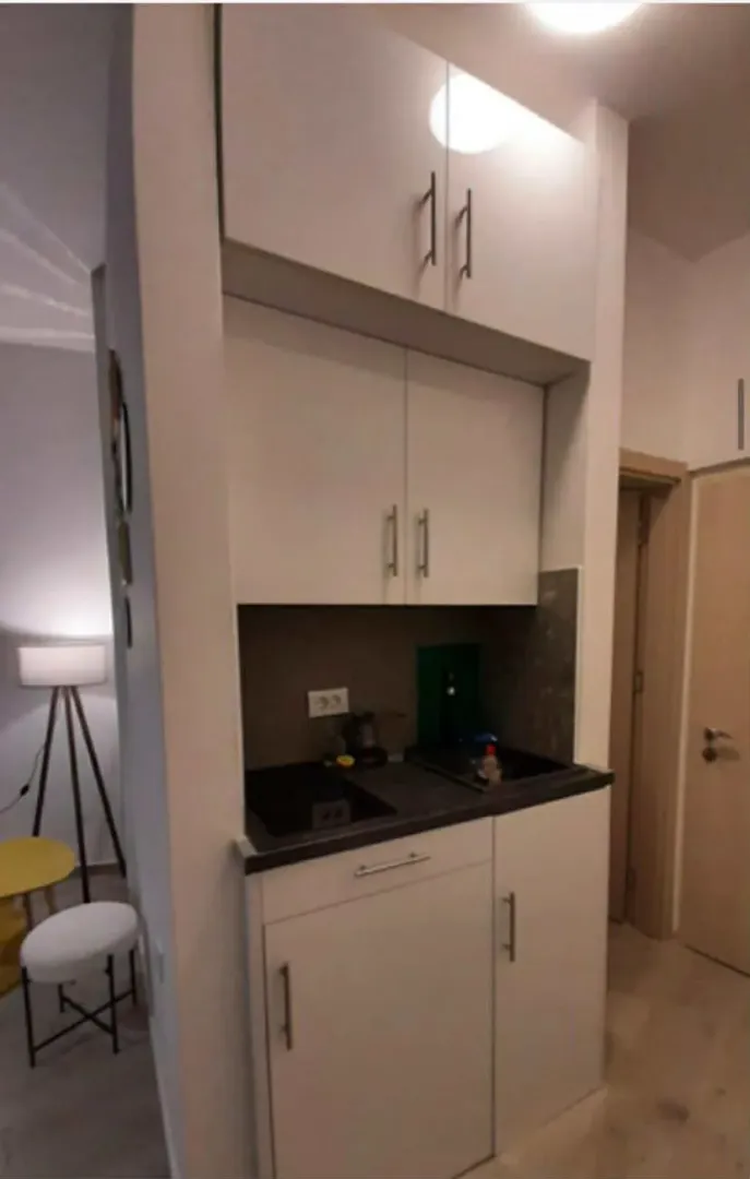 Small kitchen with white cabinets and a built-in sink.