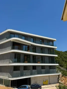 Exterior of a modern residential building with balconies and large glass surfaces. - image 13