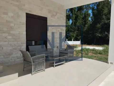 Covered terrace with outdoor seating and a view of the yard. - image 14