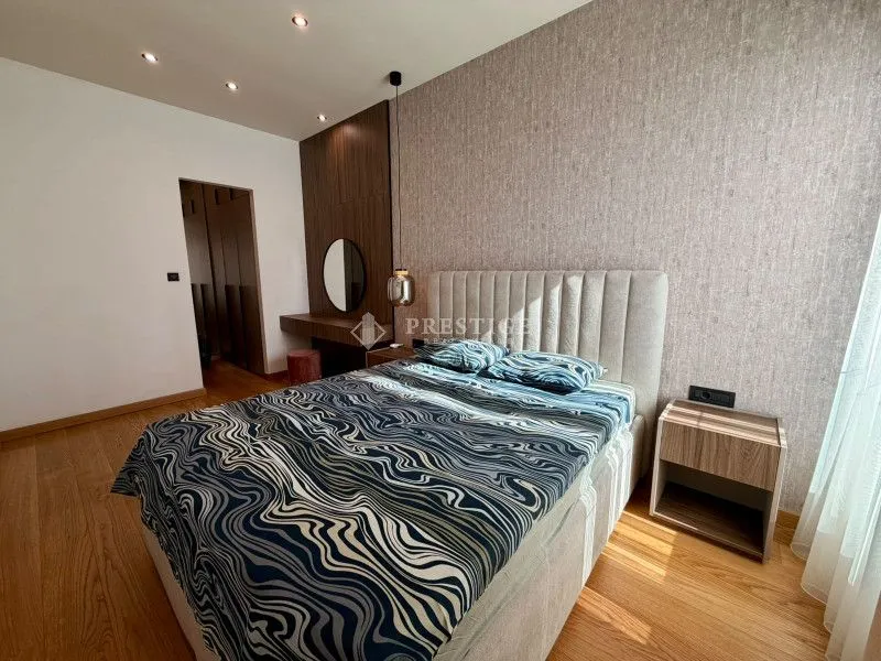 Modern bedroom with a double bed, bedside tables, and a wardrobe.