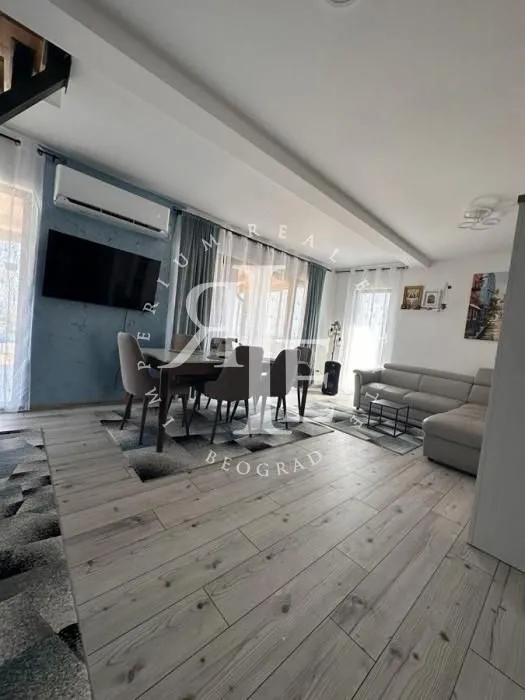 Spacious living room with a seating set and a dining area.