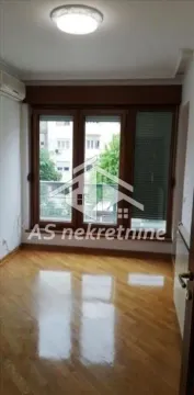 Empty room with wooden flooring, a large window, and an air conditioning unit. - image 4