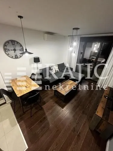 Living room with dining area and sofa set.