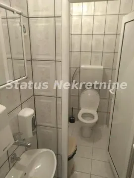 Smaller bathroom with white tiles, washbasin and toilet. - image 7