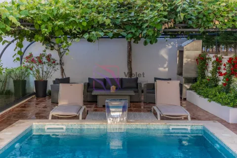 Swimming pool with sun loungers and a seating area in the yard. - image 22