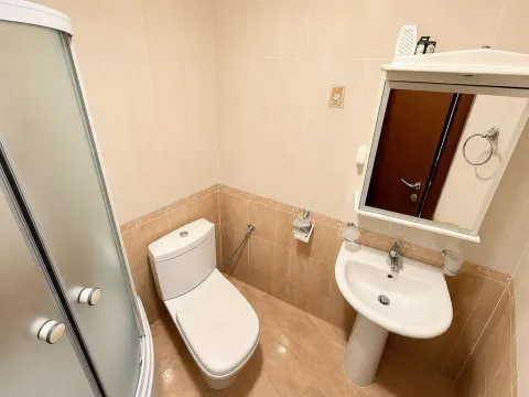 Compact bathroom with a shower cabin, washbasin, and toilet. - image 4