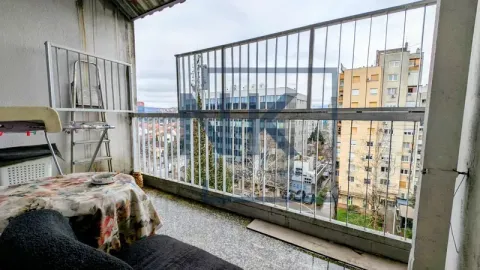 Covered balcony with railing and a view of surrounding buildings. - image 19