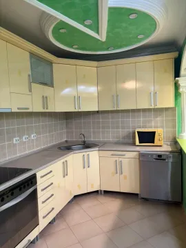 Kitchen with light-coloured cabinetry and built-in home appliances. - image 8