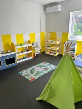 Children's room equipped with toys, shelves, and a play tent. - image 3