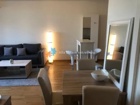 Living room with sofa, coffee table and dining area. - image 3