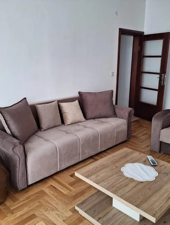 Living room with a sofa and a wooden coffee table.