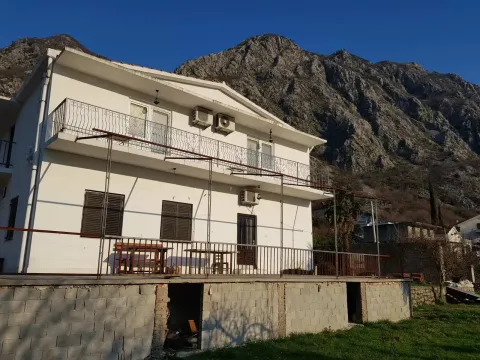 Exterior view of a two-story house with a terrace and mountain landscape in the background. - image 4