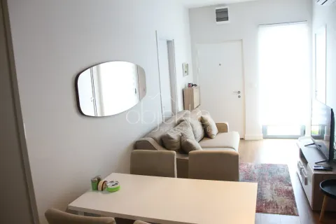 Living room with a sofa, dining table, and television. - image 7