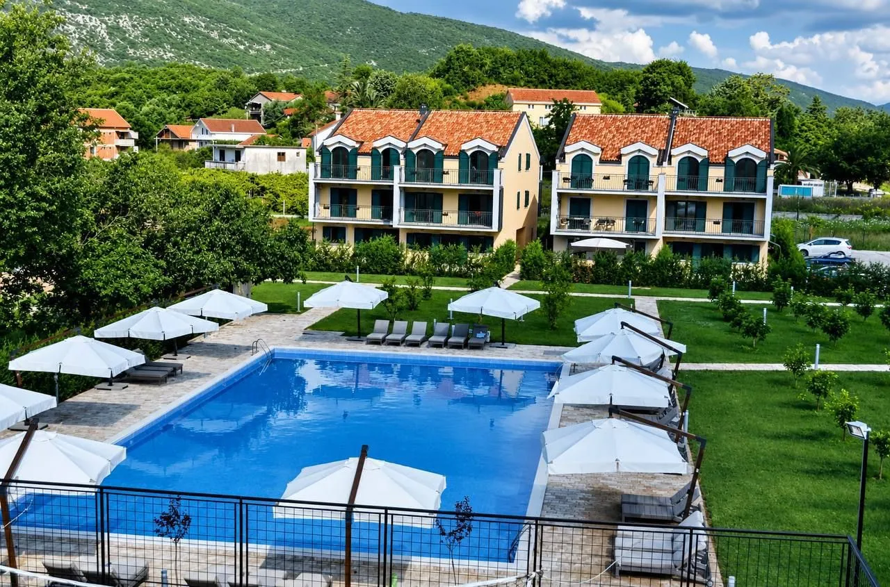 View of the building with a swimming pool and landscaped courtyard.
