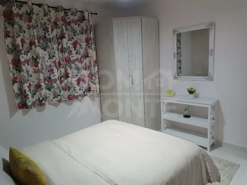 Furnished bedroom with a double bed, wardrobe, and a mirror. - image 8