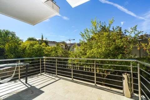 Spacious balcony with metal railing and green surroundings view. - image 9