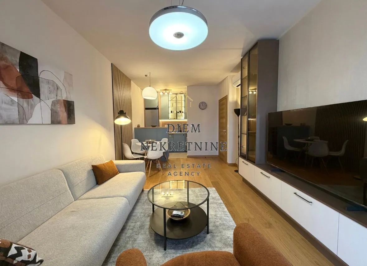 Living room with sofa and TV unit.