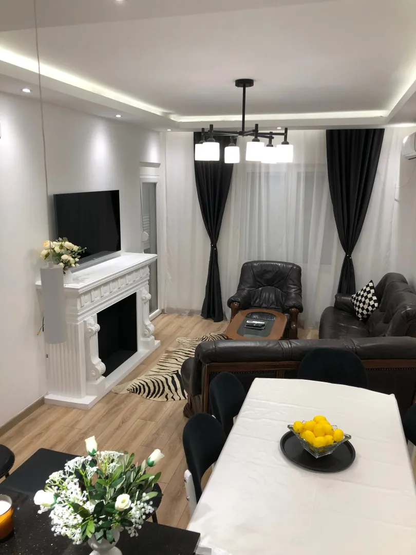 Spacious and bright living room with a fireplace and dining area.