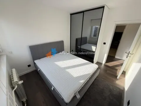 Bedroom with a double bed and a fitted wardrobe with a mirror. - image 7