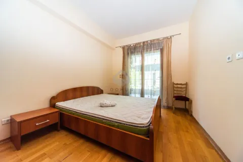 Bedroom with a double bed, wooden floor and access to the terrace. - image 6