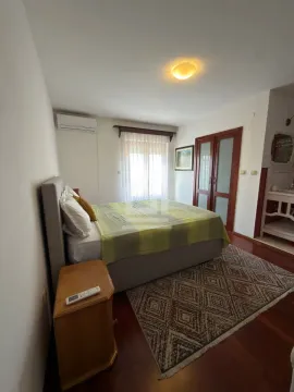 Bedroom with a double bed, nightstand, and wardrobe. - image 12