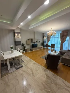 Spacious living room with dining area and modern ceiling lighting. - image 3