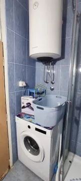Bathroom with a washing machine, water heater and shower cabin. - image 8